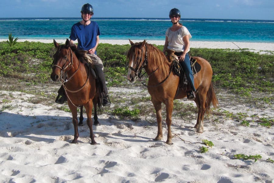 Simon and Erin horse riding on beach