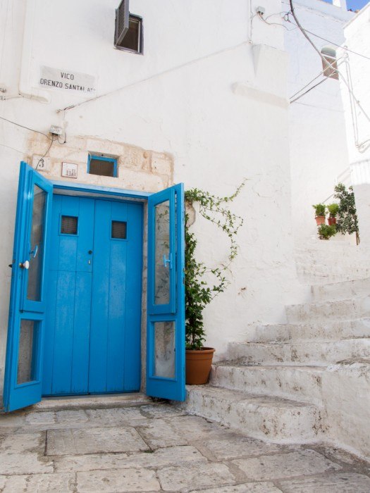 Blue door on a white street of Ostuni, Puglia