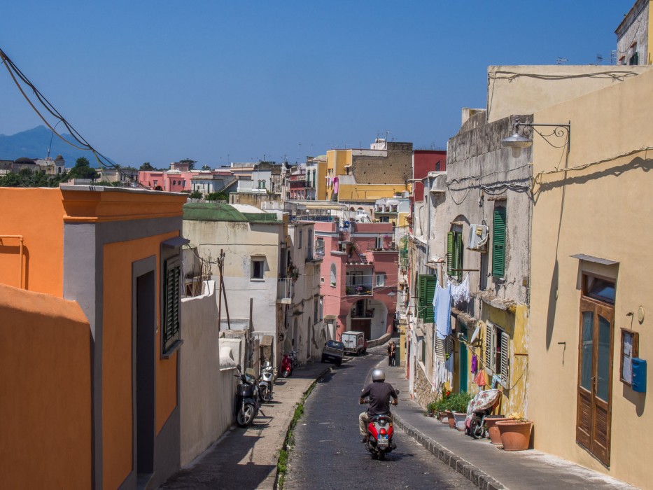 Moped driving down a road on Procida island, Italy