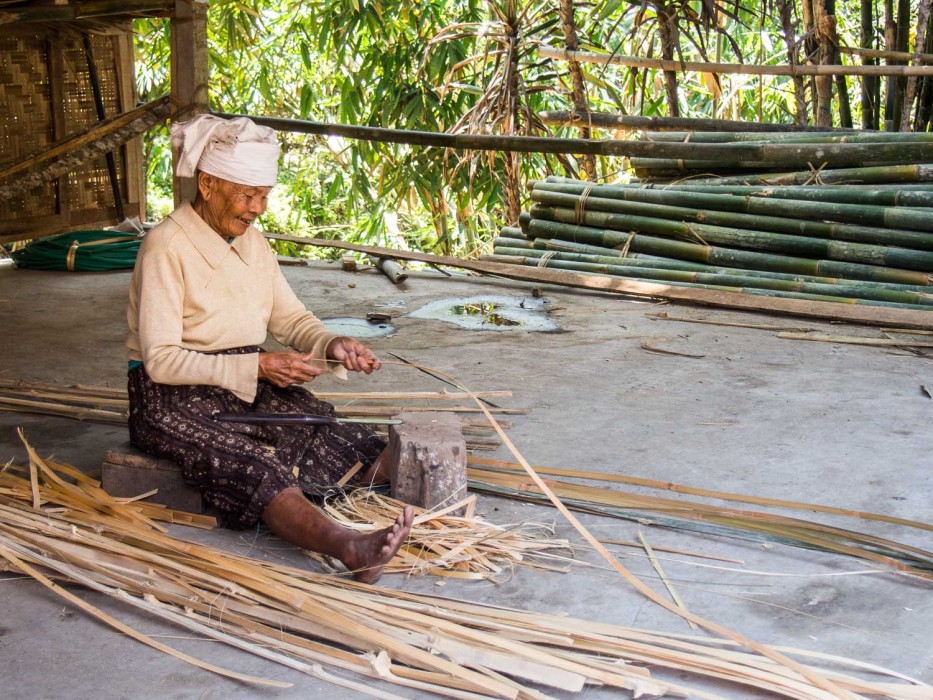 Balinese woman stripping bamboo