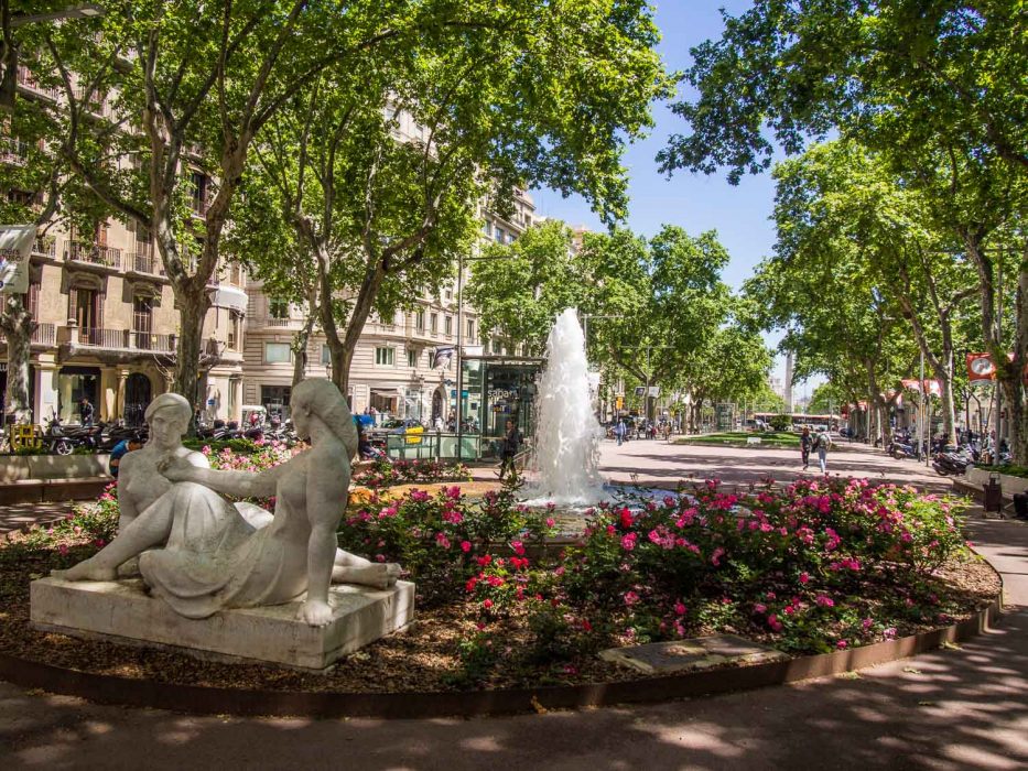 Flowers and water fountain in Gracia Barcelona square, Spain