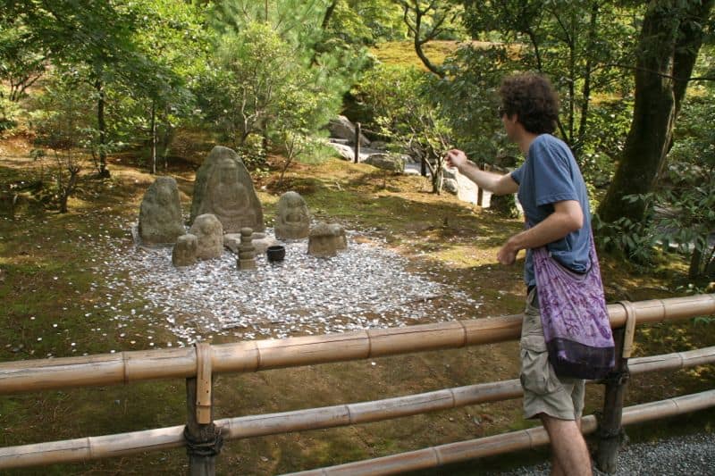 Simon throwing money at the Golden Temple, Kyoto