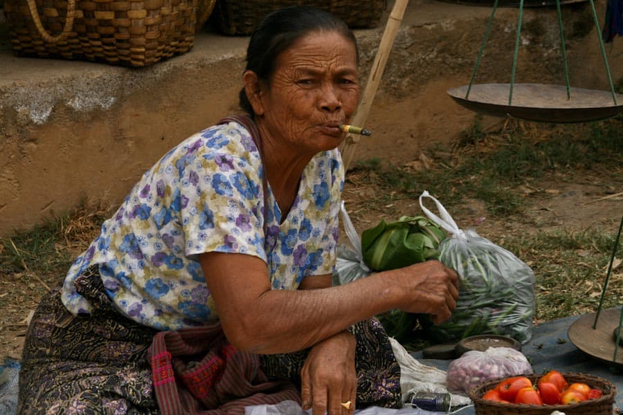 Market vendor smoking a cheroot, Burma Market vendor smoking a cheroot, Burma