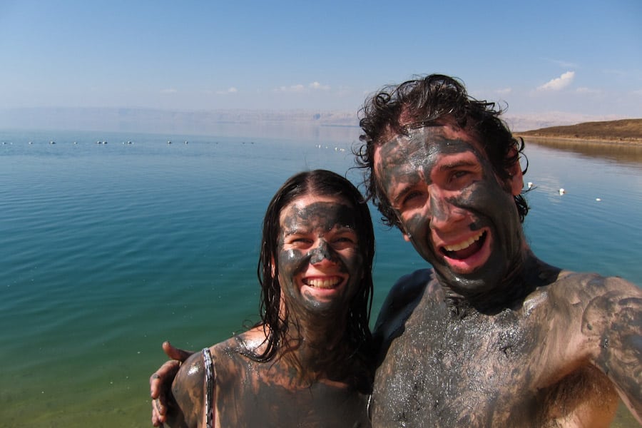 Simon and Erin covered in mud at the Dead Sea, Jordan