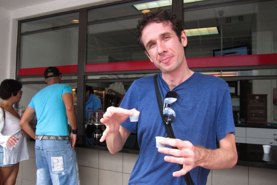 Simon with our *cafecito* at the *ventana* of Abuela's Cuban Kitchen