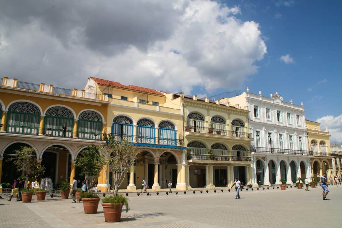 Havana for tourists A shot across a tree-lined plaza with beautifully painted buildings on the far edge
