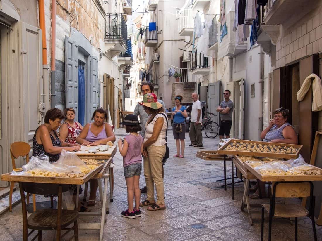 Women making orecchiette pasta on the streets of Bari, Puglia