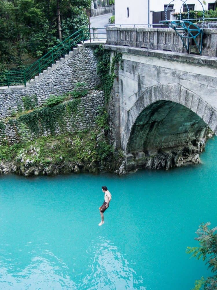 Simon jumping off the Most na Soči bridge, Emerald River Adventure