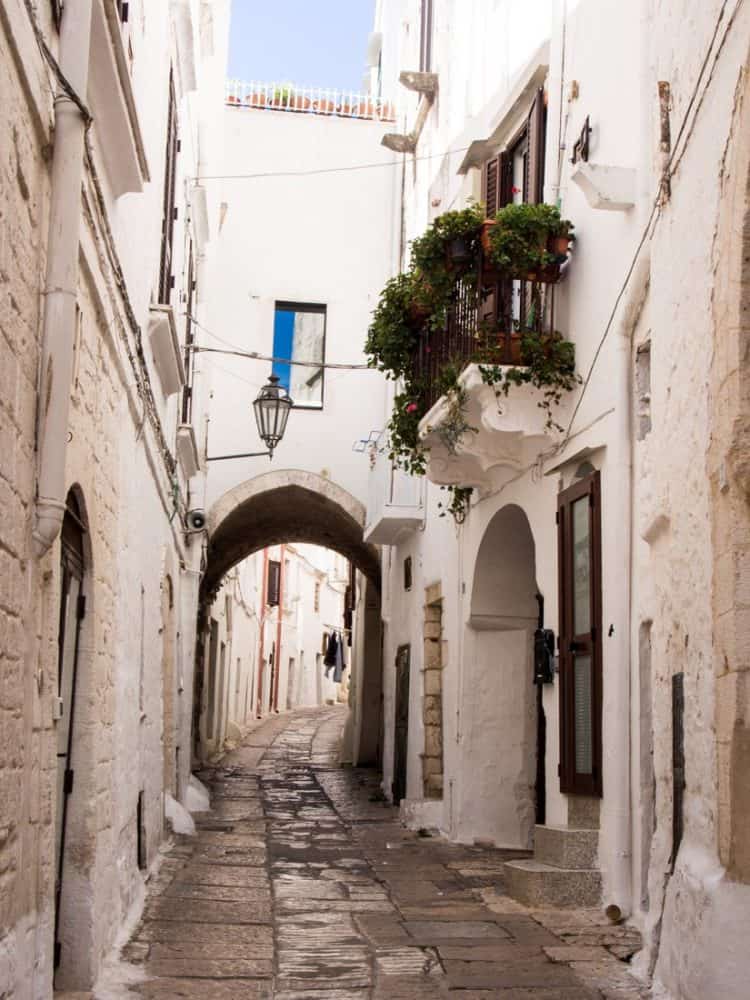 Narrow street with archway in Ostuni old town, Puglia