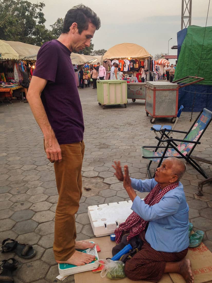 Simon getting weighed at the Night Market in Phnom Penh