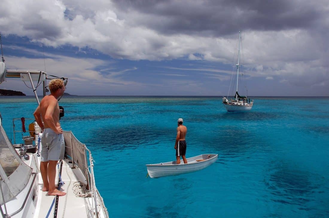  Jamie and a friend consider the weather in approaching clouds; Havannah Harbor, Vanuatu