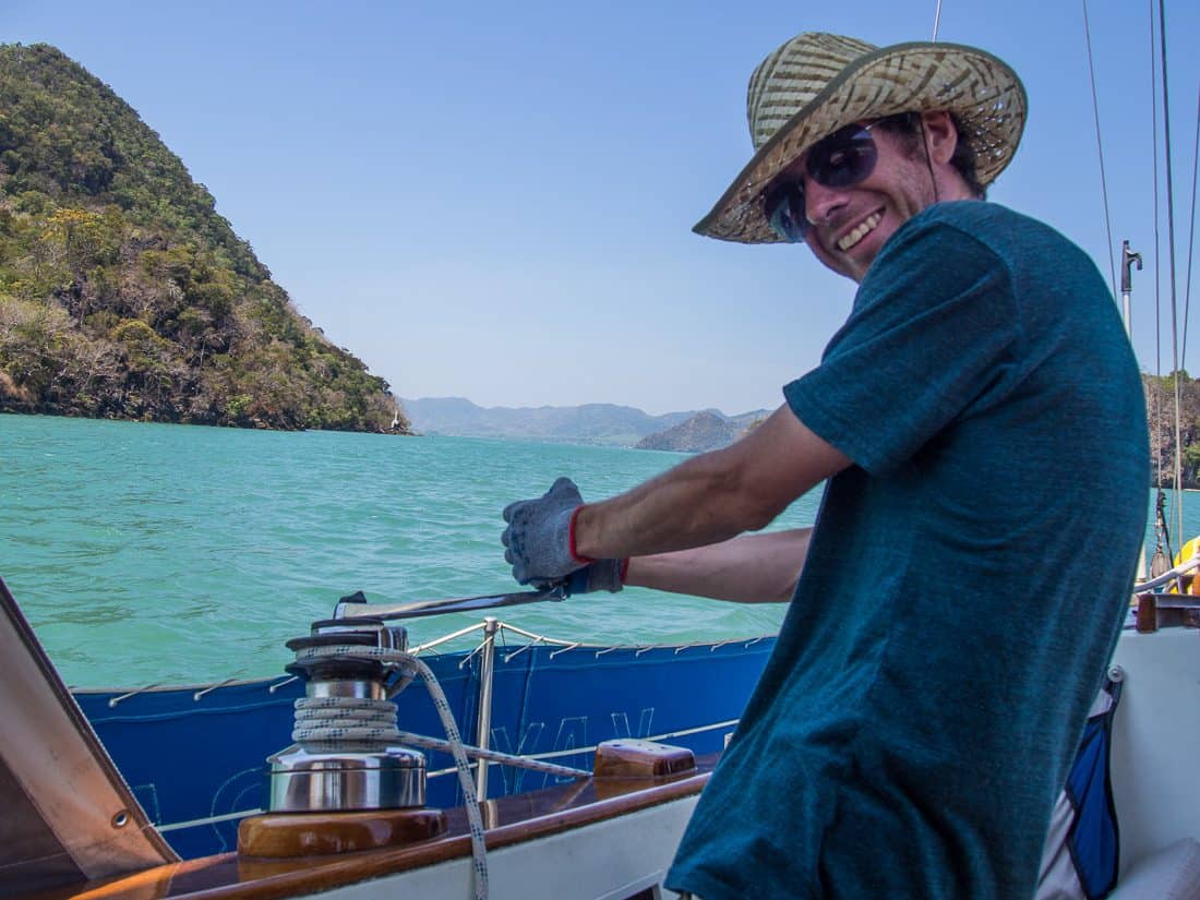 Simon bringing in the headsail with the winch, Langkawi sailing school