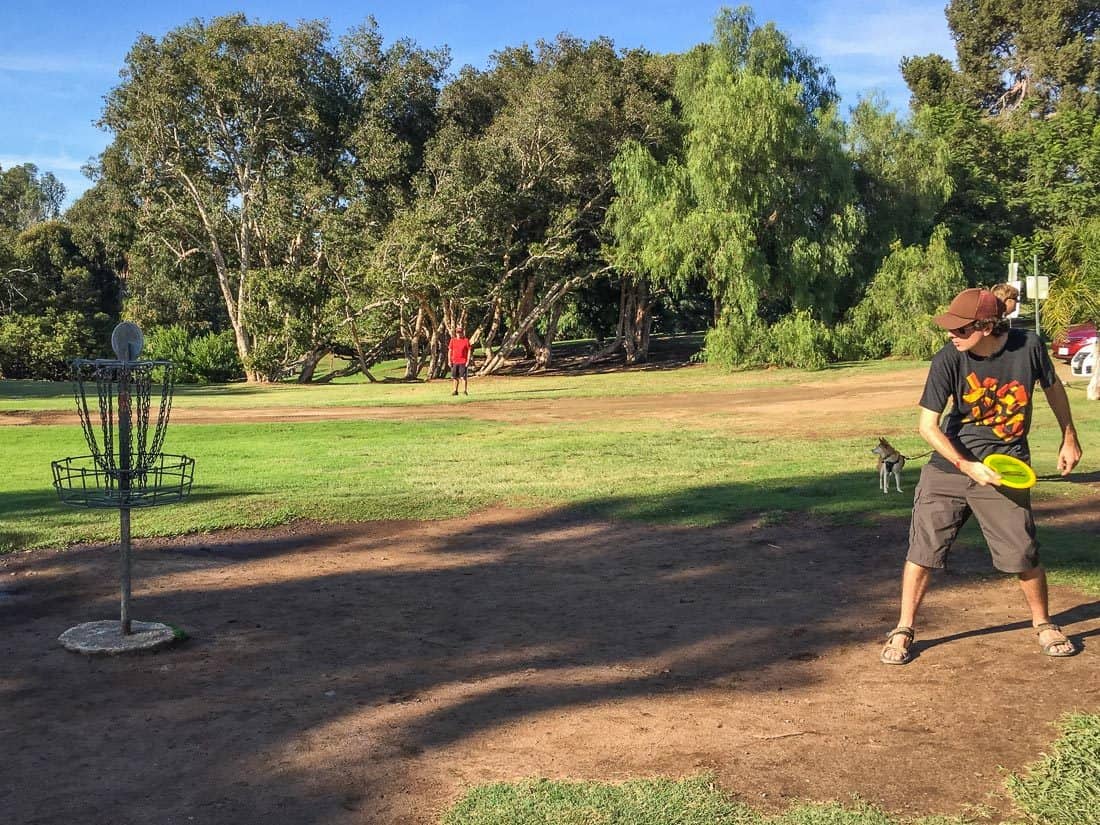 Simon playing disc golf at Morley Field