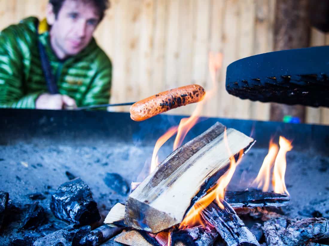 Simon grilling a veggie sausage in Oulanka National Park