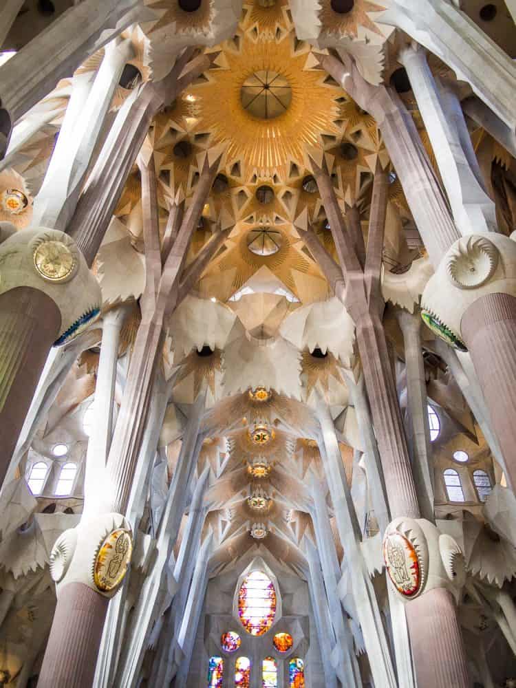 Interior view of the tall columns and ceiling of Sagrada Familia, Barcelona