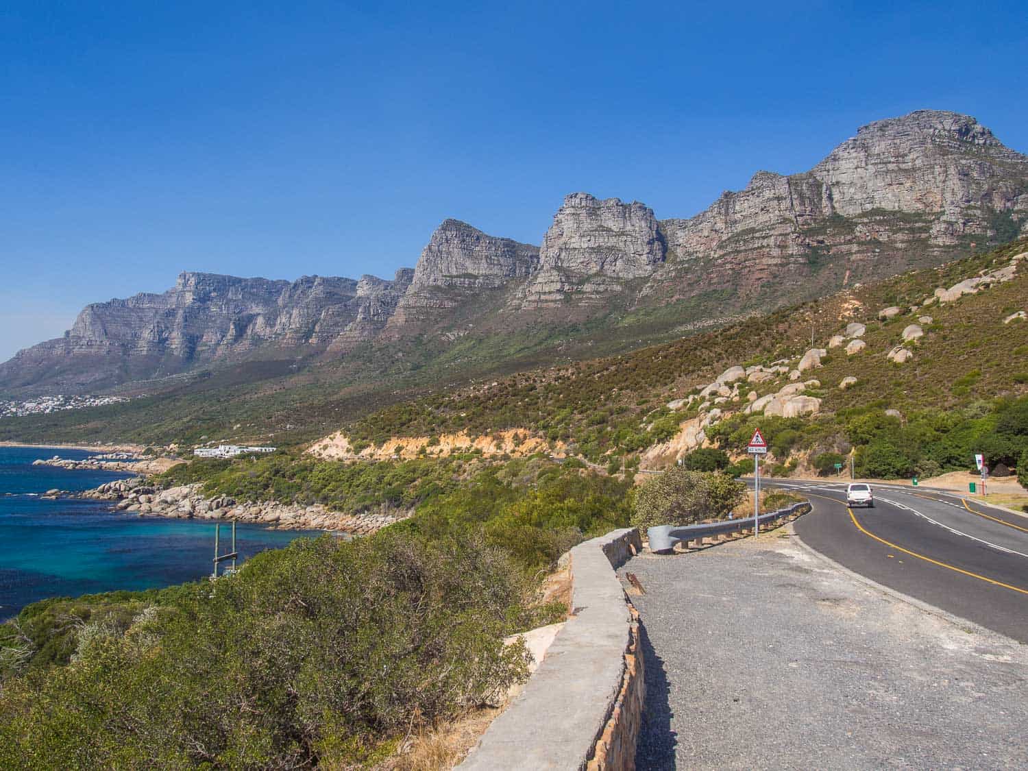 Victoria Road on the way to Camp's Bay with a view of the Twelve Apostles mountains
