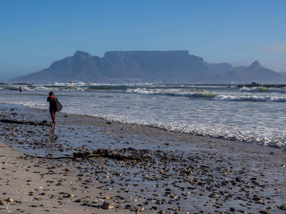 Surfer at Bloubergstrand beach in Cape Town
