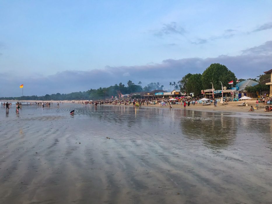 The many fish restaurants on Jimbaran beach at busy at sunset