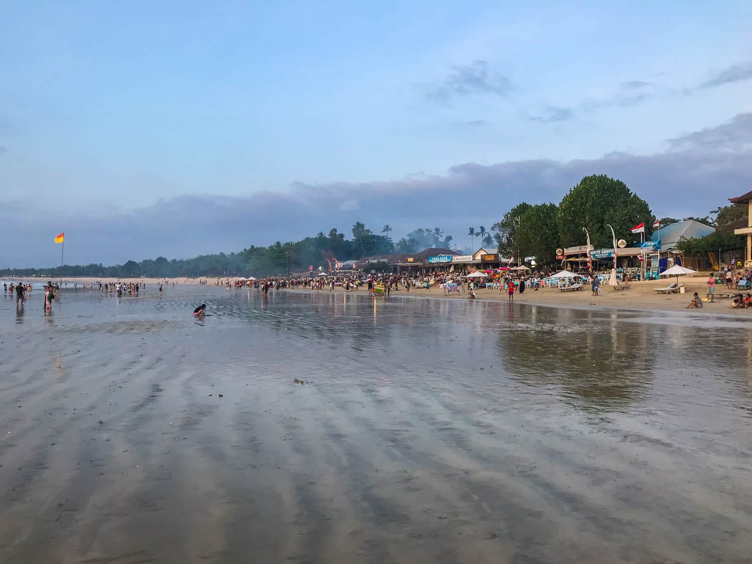 The many fish restaurants on Jimbaran beach at busy at sunset