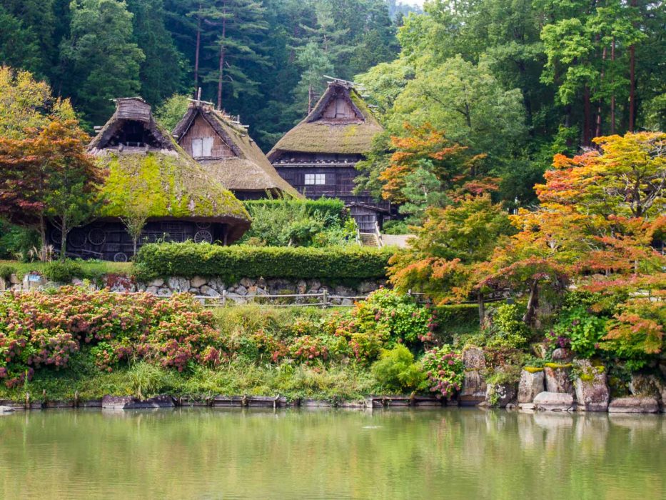 Traditional grass roof houses at the Hida Folk Village in Takayama with autumn colours