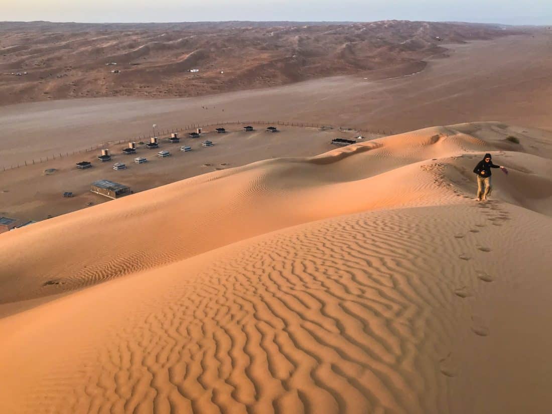 Hiking up the sand dune next to Desert Retreat Camp, Wahiba Sands, Oman