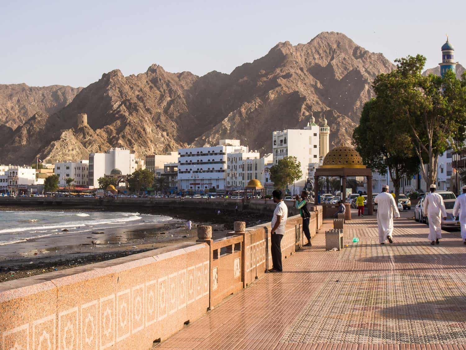 People walking along Mutrah Corniche in Muscat, Oman