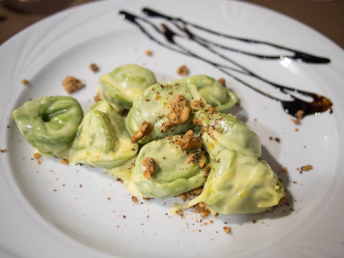 Green tortelloni with a walnut and saffron sauce at Trattoria Del Rosso in Bologna, Italy