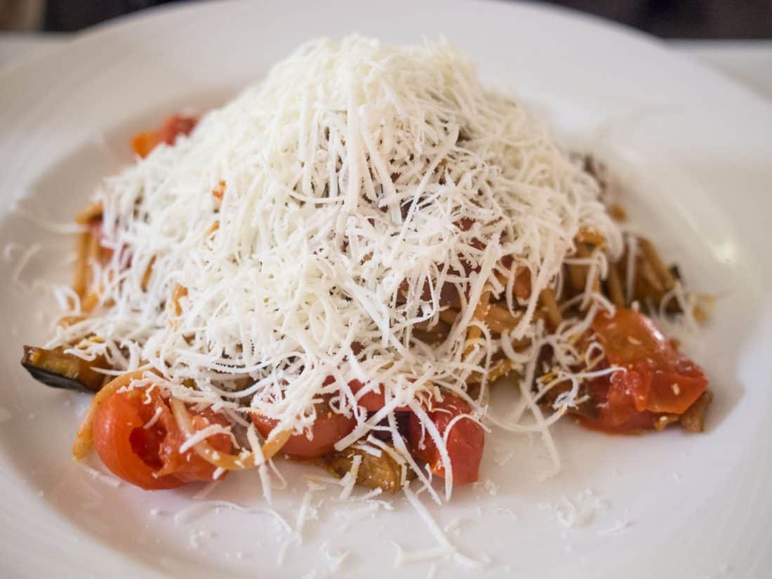 Farro spaghetti with tomatoes, aubergine and a mountain of ricotta cheese at Osteria degli Spiriti, one of the best restaurants in Lecce, Italy