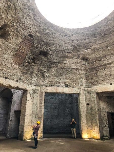 Visitors with hard hats in the octagonal room at the Domus Aurea or Golden House in Rome, Italy