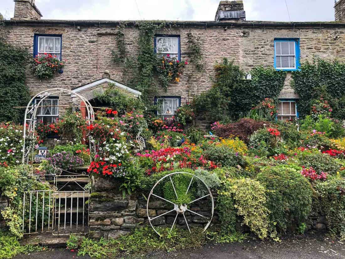 Flower covered cottages in Millthrop village on the Dales Way hike, Yorkshire Dales, England
