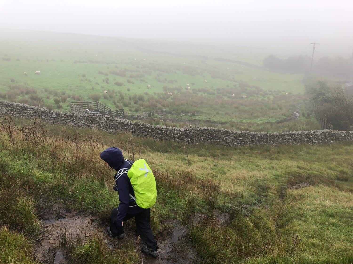 Erin in full waterproofs with backpack rain cover on the Dales Way