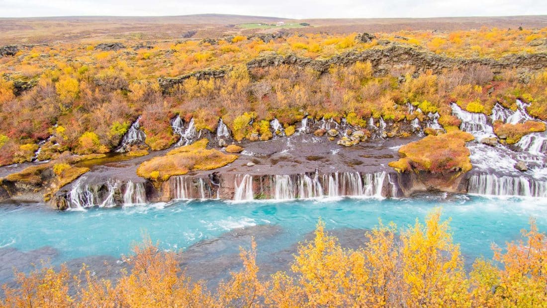 The first step of planning a trip to Iceland is choosing which season to travel in. Here are the autumn colours of Hraunfossar waterfall in September,
