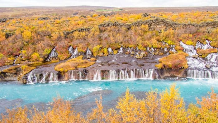 The first step of planning a trip to Iceland is choosing which season to travel in. Here are the autumn colours of Hraunfossar waterfall in September,