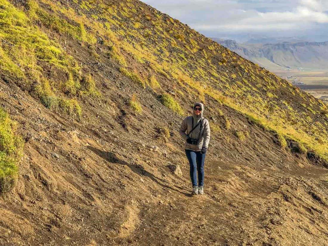 What to wear in Iceland - Erin walking up to Rauðfeldsgjá Gorge in down jacket, jeans and hiking shoes