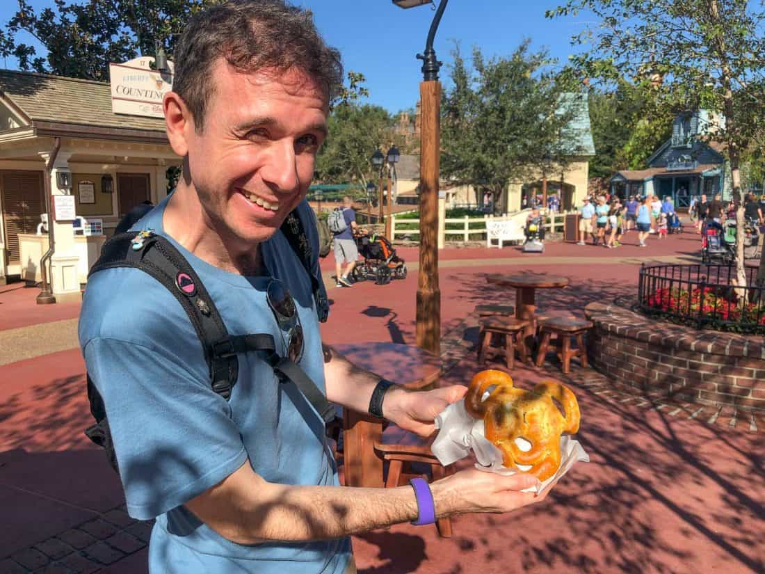 Simon with a Mickey pretzel at Disney World