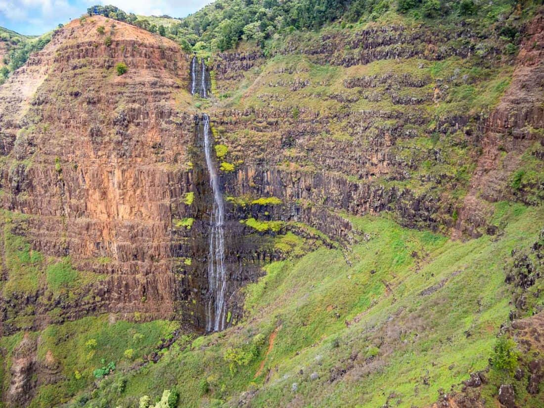 Waterfall at Waimea Canyon on a doors off helicopter Kauai tour with Jack Harter in Hawaii