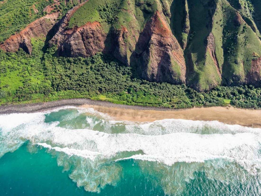 Crashing waves on a beach on the Napali coast on Kauai on a doors off helicopter tour with Jack Harter in Hawaii