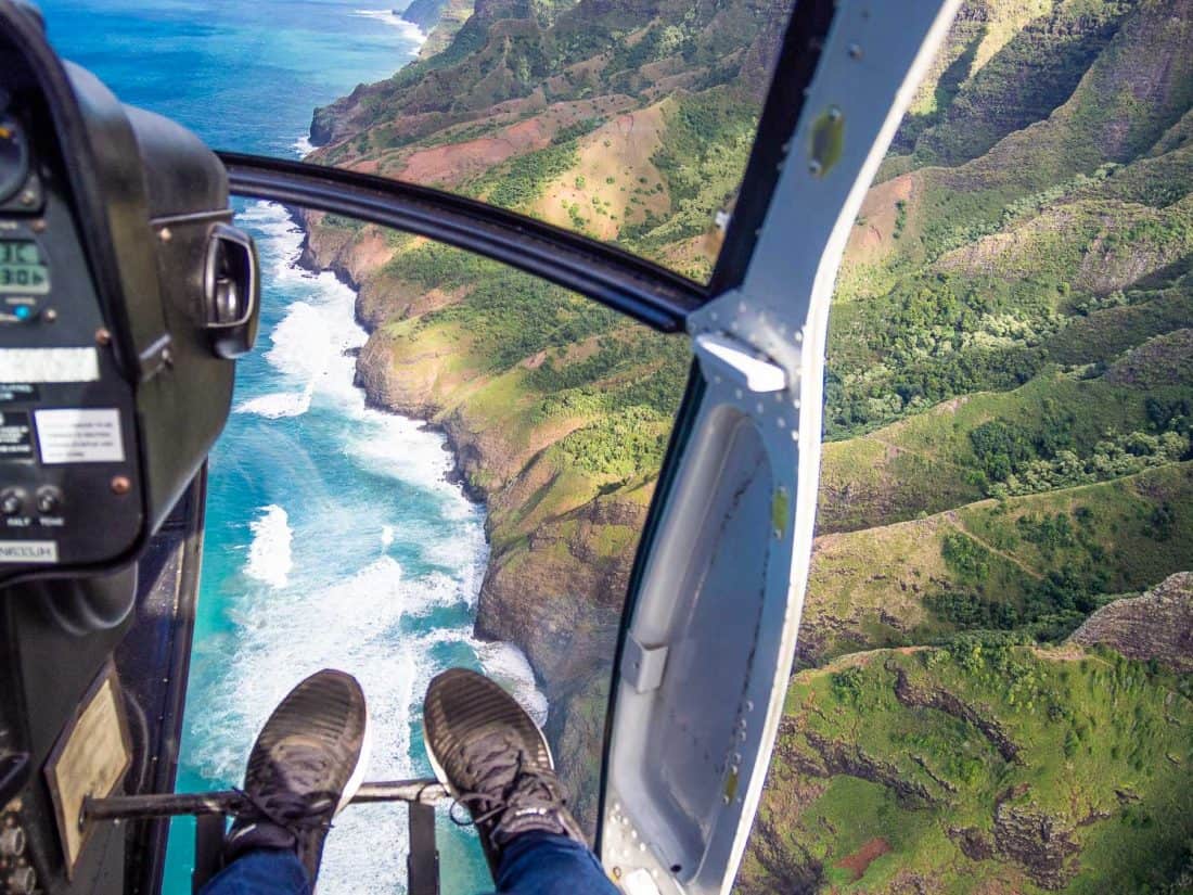 Sitting next to the lack of door on a Jack Harter helicopter tour on Kauai and the Napali Coast, Hawaii, USA