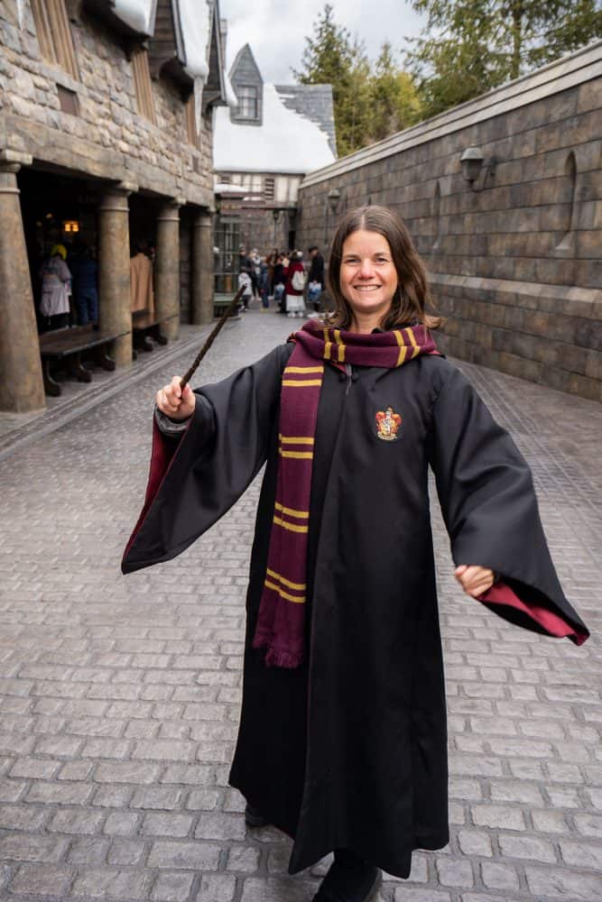 Erin dressed in Harry Potter robe and wand at The Wizarding World of Harry Potter at Universal Studios Japan in Osaka