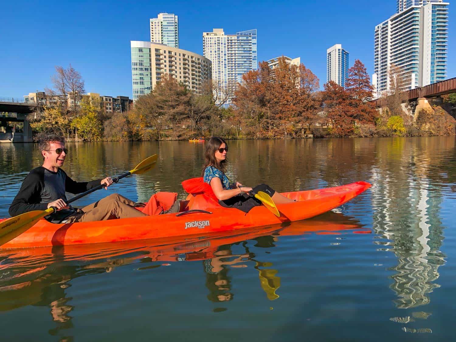 Kayaking past downtown Austin on a sunny day in December