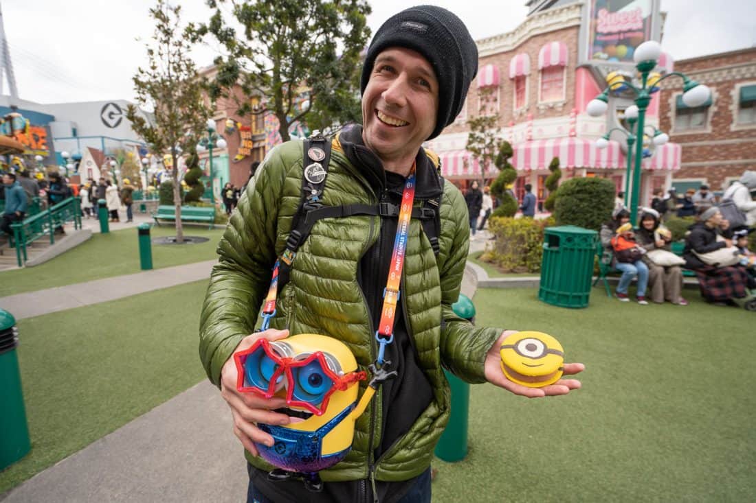 Simon Fairbairn with a Minion popcorn bucket and cookie sandwich in Minion Park at Universal Studios Osaka