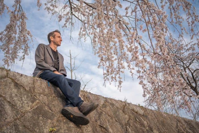 Bluffworks jeans review - Simon wearing the Departure travel jeans under the cherry blossoms in Kyoto