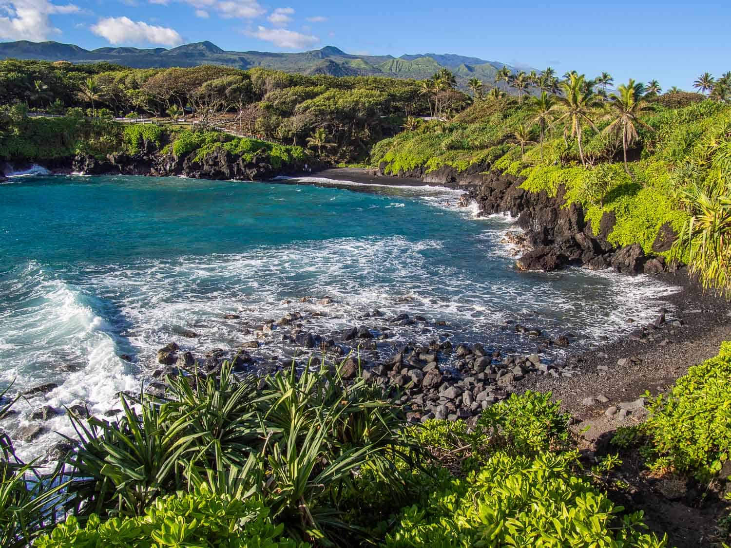 The black sand beach at Waianapanapa State Park, one of the best road to Hana stops on the island of Maui in Hawaii