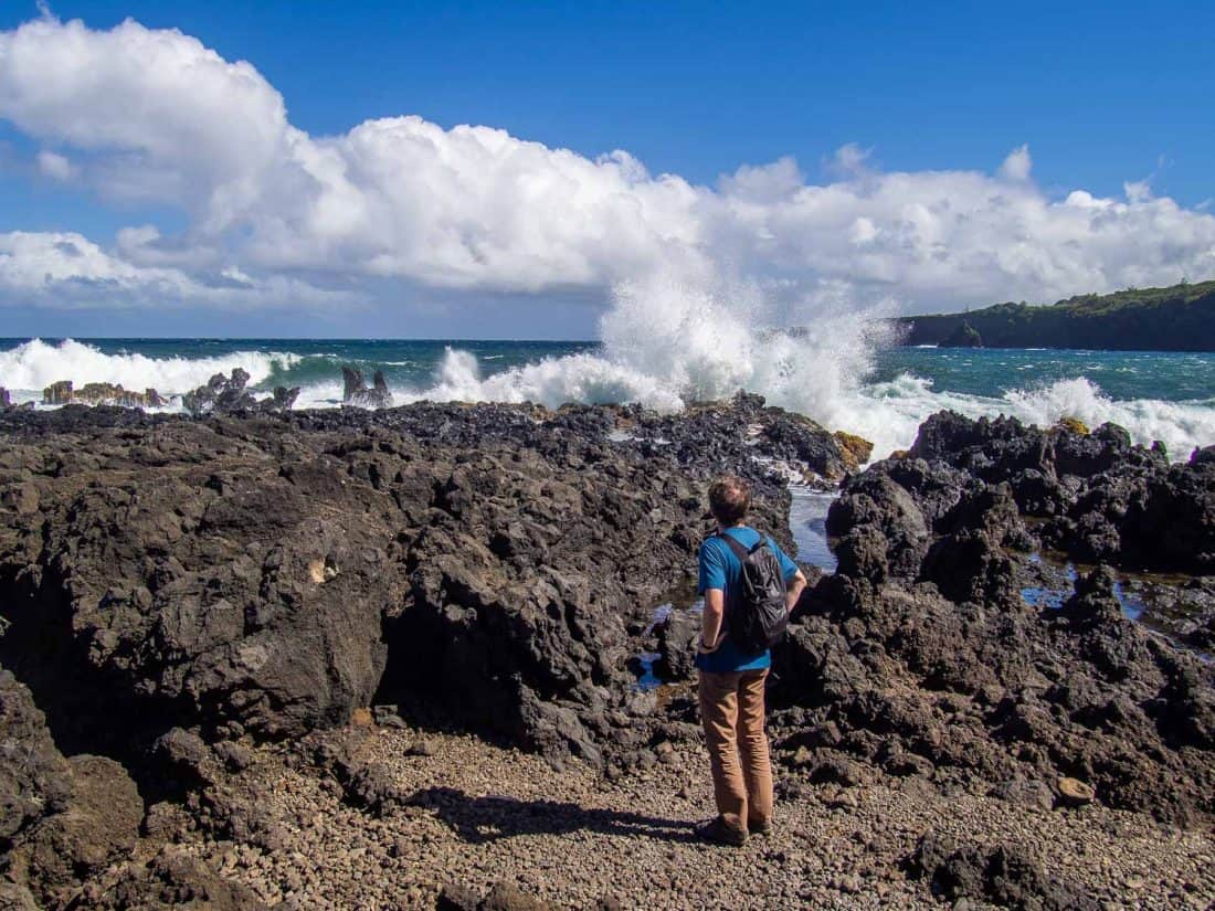 Simon watching waves crashing on rocks on the Ke’anae Peninsula in Maui, Hawaii, USA