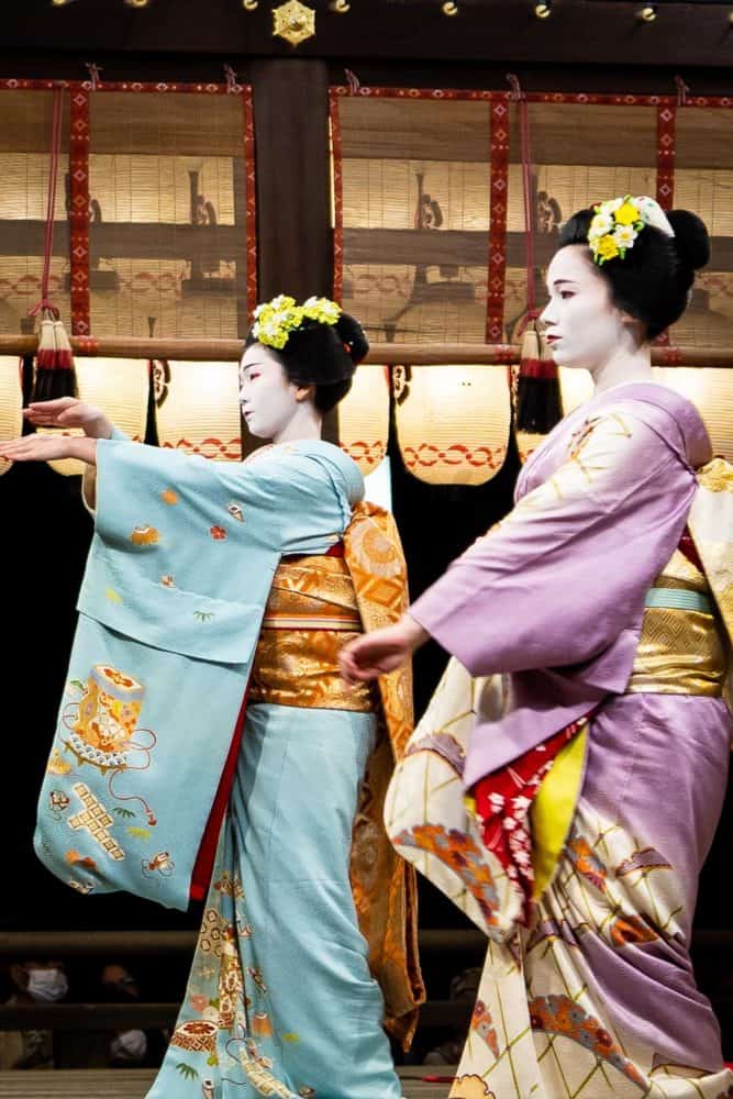 Geishas dancing at Yasaka shrine in Kyoto, Japan