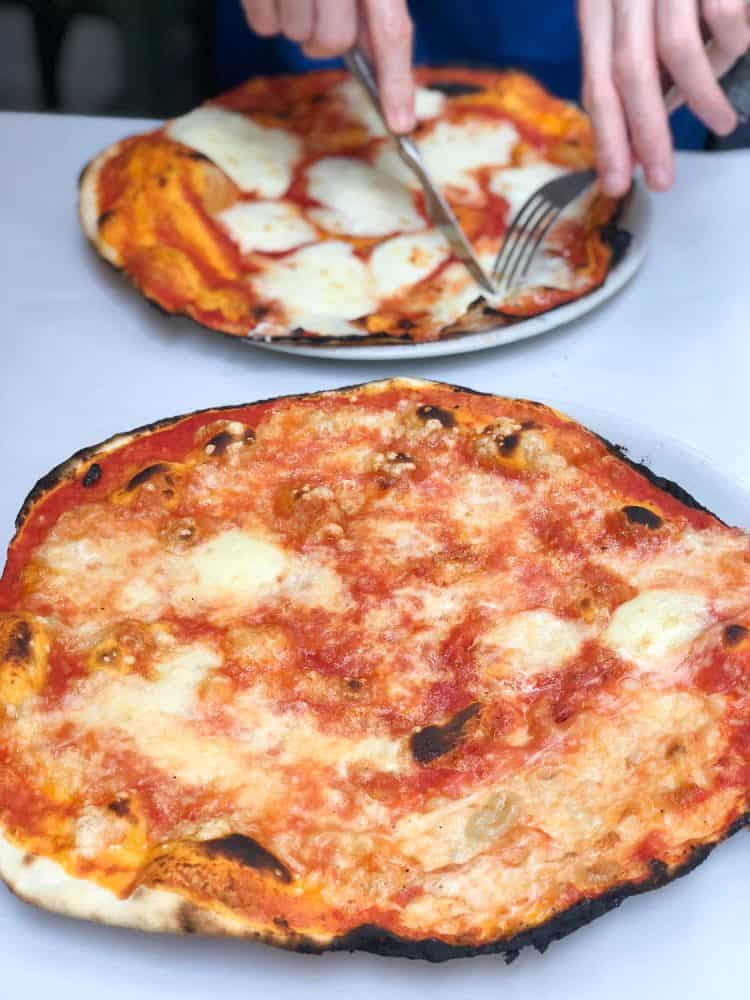 Classic margherita (front) and margherita con bufala (back) at Pizzeria da Remo in Testaccio, Rome