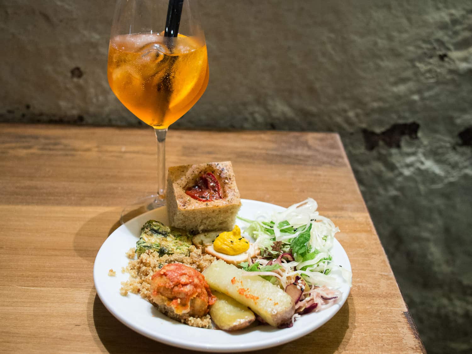 Spritz and a plate from the vegetarian aperitivo buffet at Ketumbar, Testaccio in Rome