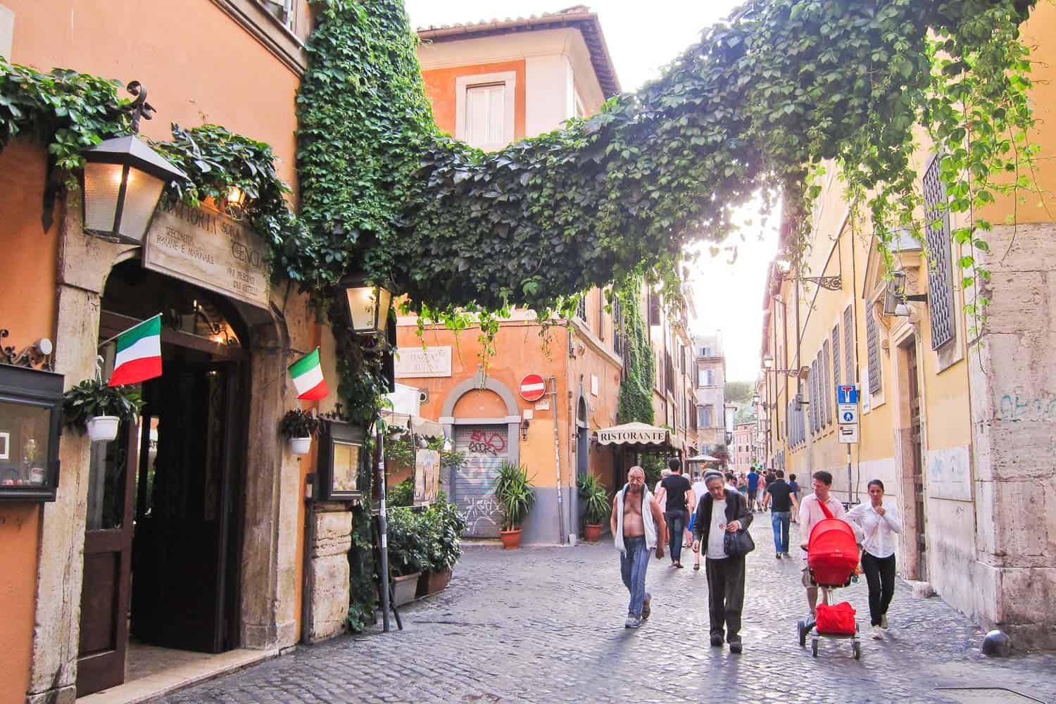 Trastevere street dripping with ivy- one of the best areas to stay in Rome, Italy