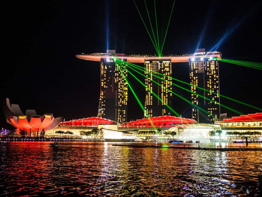 Spectra light show from the Merlion fountain with laser beams from Marina Bay Sands, Singapore