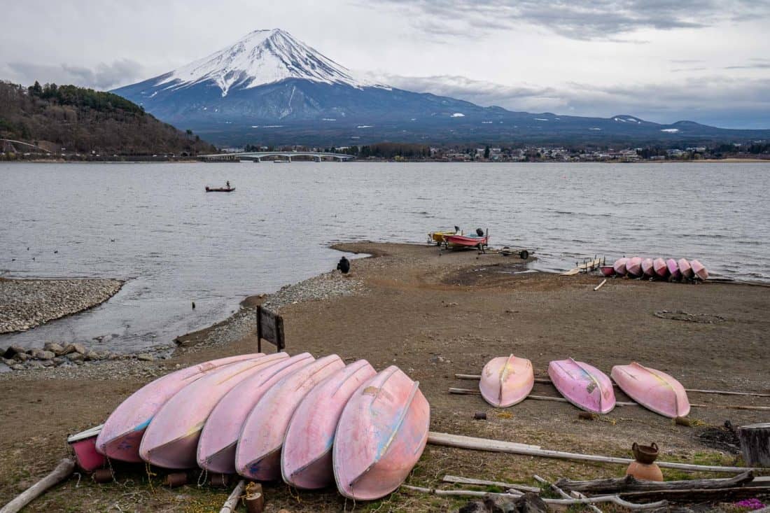 Mount Fuji at Lake Kawaguchiko on a cloudy day on the north shore with boats in the foreground, Japan